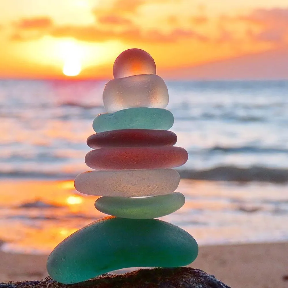 Coloured balls as a balancing rock in a sunset